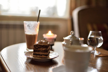 Cafe table with coffee cake glass and candle