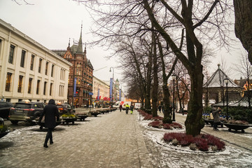 Oslo / Norway - December 1 2018: people walk on footpath to enjoy their holidays in Oslo in snowy day in winter