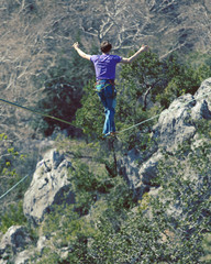 Obraz premium Man balancing on the rope concept of risk taking and challenge.