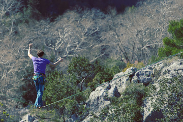 Obraz premium Man balancing on the rope concept of risk taking and challenge.