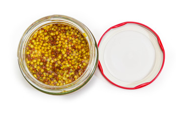 Top view of French mustard in jar with open lid