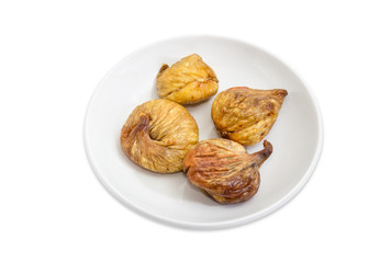 Dried figs on the white saucer
