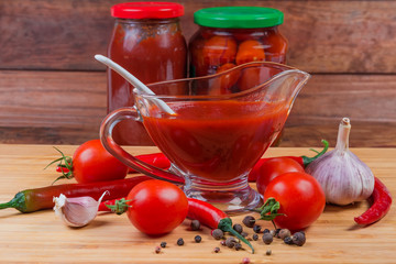 Tomato sauce in glass gravy boat, ingredients, canned tomato products