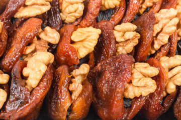Dry-cured apricots stuffed with walnuts and raisins close-up