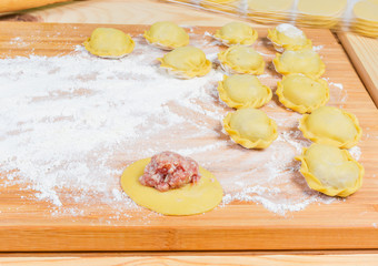 Homemade meat dumplings on the cutting board during preparation