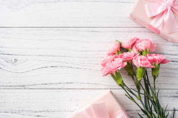 top view of carnation on white wooden background