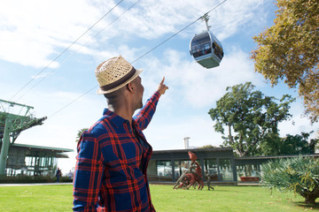 african american man pointing finger to cable car