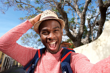 Close up happy african american travel man taking selfie