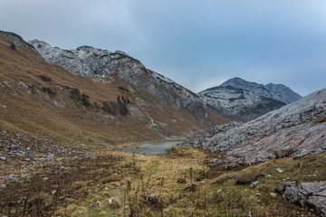 Gloomy weather. Landscape rocky mountains Styrian Alps in Austria. High peaks of mountains and under them mountain lake.