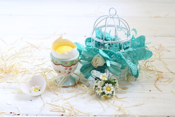 Easter still life with an egg and a decorative cage on a white background
