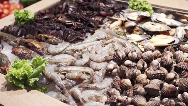 Close view of row seafood in Bangkok food court: shripms, mussels, scallops. Thailand