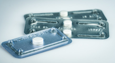 Emergency contraceptive pills in blister pack on blurred background of morning after pills. Drug cause of ectopic pregnancy. Emergency contraception for prevent pregnancy after unprotected sex.