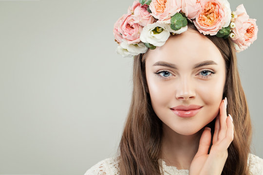 Young Woman with Healthy Clear Skin, Brown Hair, Natural Makeup and Flowers Wreath on her Head, Fashion Beauty Portrait