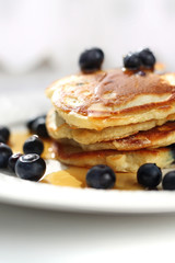  Pancakes with blueberries and maple syrup. Sweet breakfast.