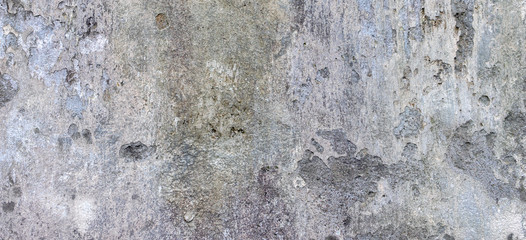 Oldgrungy weathered wall background texture. Dirty peeled plaster wall with falling off flakes of paint