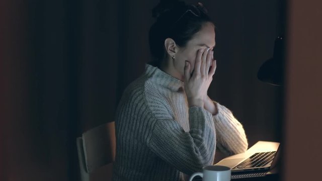 Beautiful Woman takes off his glasses and rubbing tired eyes. Female yawn and want to sleep. Problem with glasses, eyesight or vision. Working late with computer. Astigmatism, myopia or insomnia.