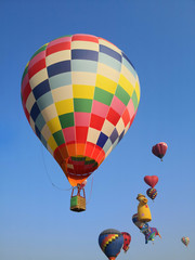 Fototapeta na wymiar Colorful balloons flying in blue sky