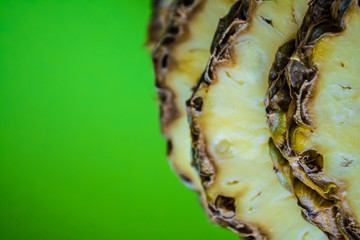 Tropical citrus fruit the pineapple cut on rings on a green background. Healthy food. Exotic of summer