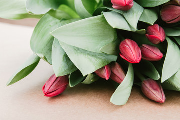 card of congratulations and tulips on a light craft background. selective focus. nature
