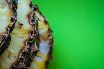 Tropical citrus fruit the pineapple cut on rings on a green background. Healthy food. Exotic of summer