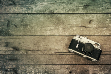 Old retro camera on wooden background
