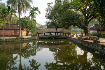 Fototapeta na wymiar Nhat Tien bridge in Thay Pagoda, one of the oldest Buddhist pagodas in Vietnam, in Quoc Oai district, Hanoi