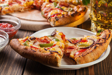 Slices of pizza with bacon, paprika and corn