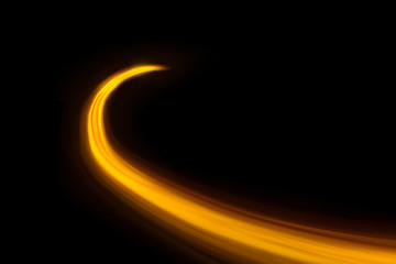Glowing shiny curve light trail lines effect in black background.