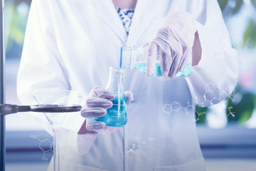 Fototapeta premium Investigator scientist hand checking test tubes, dropping liquid to test tube.