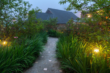Garden path in resort with warm light and trees on side at evening, Garden Decoration