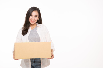 Delivery, relocation and unpacking. Smiling young woman holding cardboard box isolated on white background