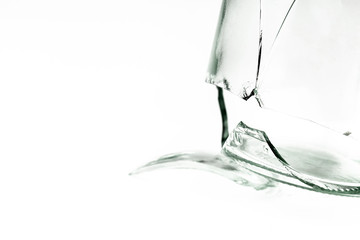 A fragment of one glass jar damaged cracked and cracked, splinters on a white background close-up.