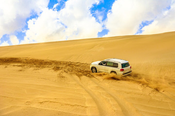 Offroad desert safari, dune bashing at Khor Al Udeid, the inland sea near Qatar and Saudi Arabian,...