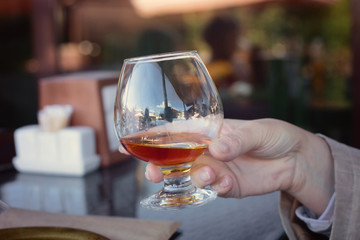 Glass of brandy in hand