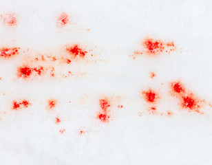 Red blood on white snow as a background