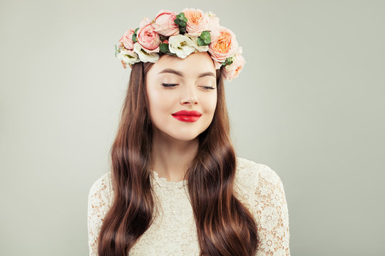 Pretty Model Looking Aside. Beautiful Woman with Long Hair, Make up and Flowers. Spring Beauty Girl