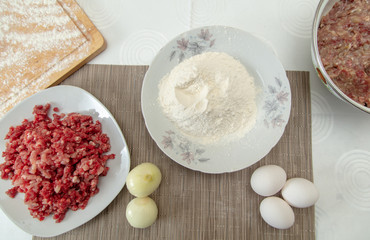 Fototapeta na wymiar Stuffing and flour in the kitchen for meatballs