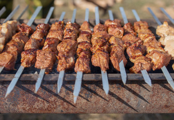 Shish kebab on skewers is fried on a brazier