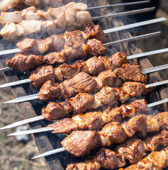 Shish kebab on skewers is fried on a brazier