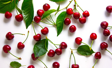 Sweet ripe  fresh cherries background. Scattered cherries on white pattern with copy space. Cherry fruit background. 