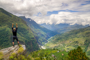 Naklejka na ściany i meble Man standing on hill top in Himalayas