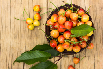 yellow cherry in sack basket o wooden table