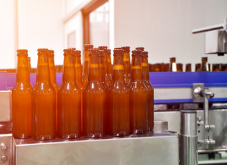 Beer bottle on conveyor belt into beer bottling process