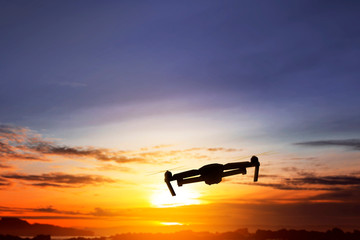 Fototapeta na wymiar Silhouette of drone with camera flying