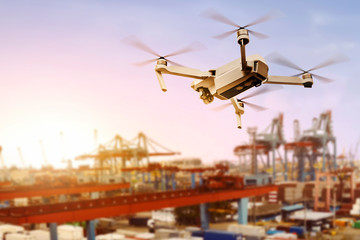 White drone with camera flying above the dock