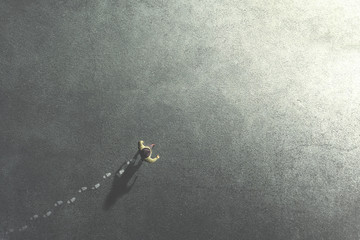 man walking in the streets leaving footsteps on the ground