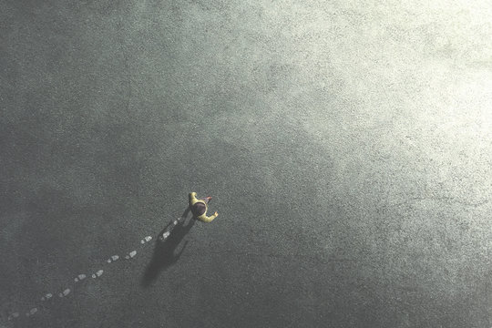 man walking in the streets leaving footsteps on the ground