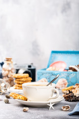 Naklejka na ściany i meble Snack with coffee and biscuits with seashells and decorations. Dreams of sea vacation and concept. Copy space.