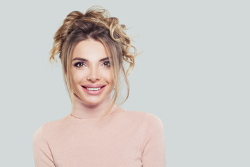 Happy casual woman in pink turtleneck on white background. Pretty model girl smiling, portrait