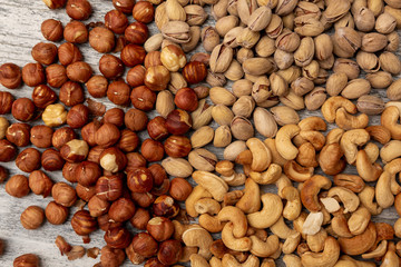 pistachio nuts cashew hazelnuts on wooden background